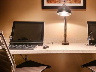 A Desk With A Laptop Computer Sitting On Top Of A Table